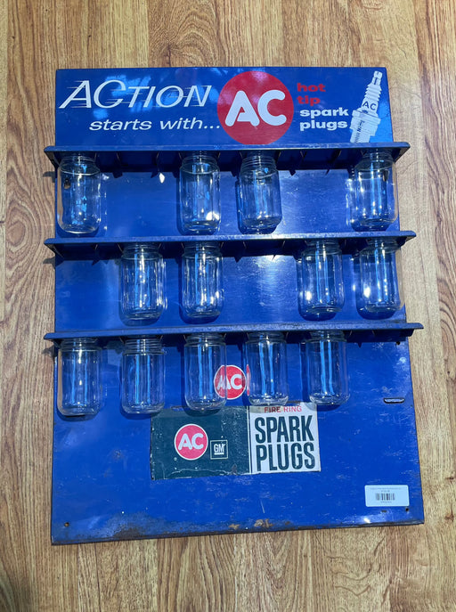 AC Spark Plug Display with Bottles Sign